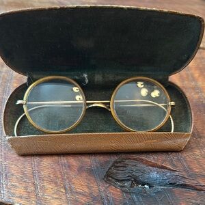 Antique gold and I believe tortoise shell glasses.